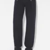 Die Denim-Jeans mit Druckknöpfen Die Denim-Jeans mit Druckknöpfen